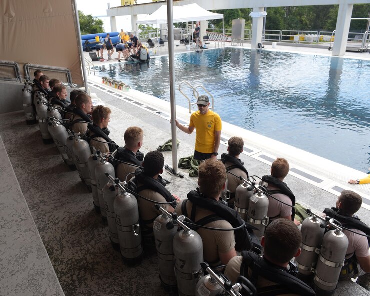 An instructor gives a briefing to diving students before a training exercise at Naval Support Activity Panama City, Fla., Aug. 2, 2017. The diving instructors teach qualified candidates how to become proficient military divers in support of naval, joint and allied operations.