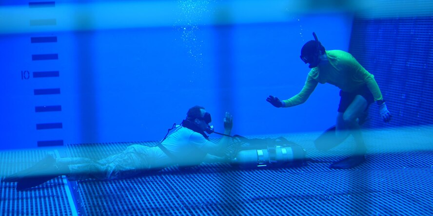 A Naval Diving and Salvage Training Center instructor signals to one of his students during a training exercise at Naval Support Activity Panama City, Fla., Aug. 3, 2017. The instructors that teach the Airmen are a mix of both active-duty and civilians with extensive experience in military diving.