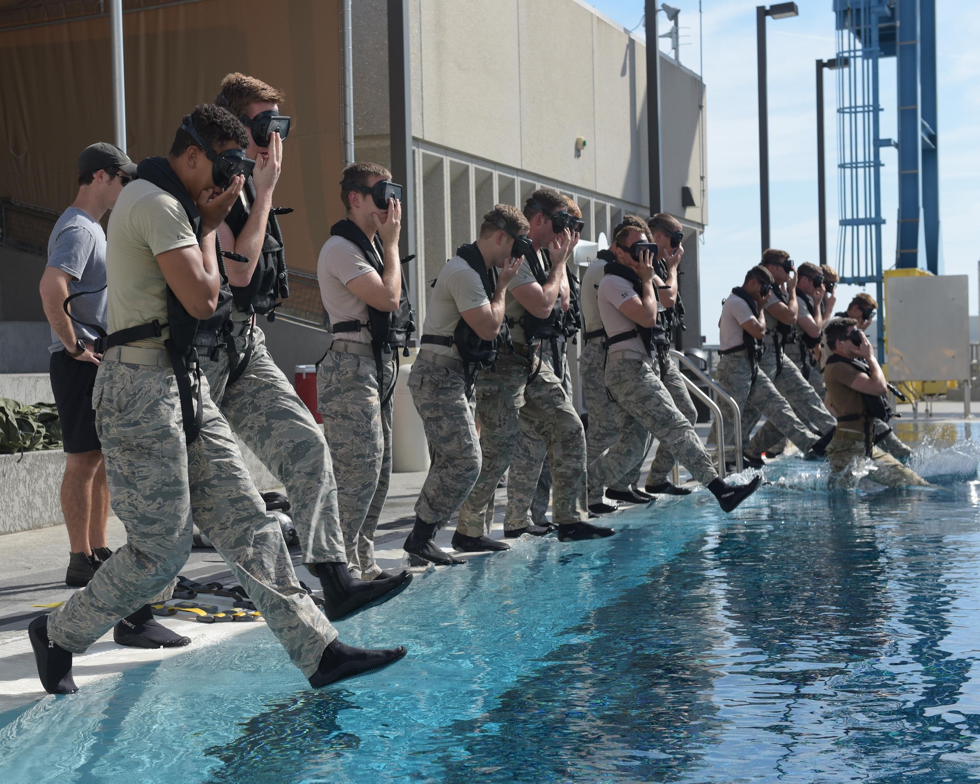 U.S. Air Force diving students take the plunge for their first dive of the day at Naval Support Activity Panama City, Fla., Aug. 2, 2017. The Naval Diving and Salvage Training Center is the home of research, development, testing and evaluation on diving matters. Certification and training is conducted constantly to support the nation's military diving requirements.