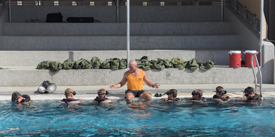 Sean McGinley, Naval Diving and Salvage Training Center instructor, gives tips to students going through the course at Naval Support Activity Panama City, Fla., Aug. 2, 2017. The diving instructors teach qualified candidates how to become proficient military divers in support of naval, joint and allied operations.