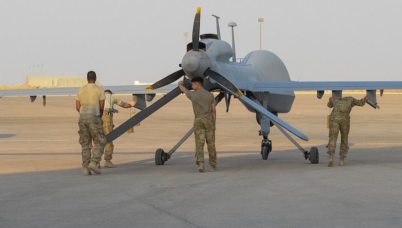 Soldiers from Company D, 10th Aviation Regiment, 10th Mountain Division, move a MQ-1C Gray Eagle unmanned aerial vehicle into position.