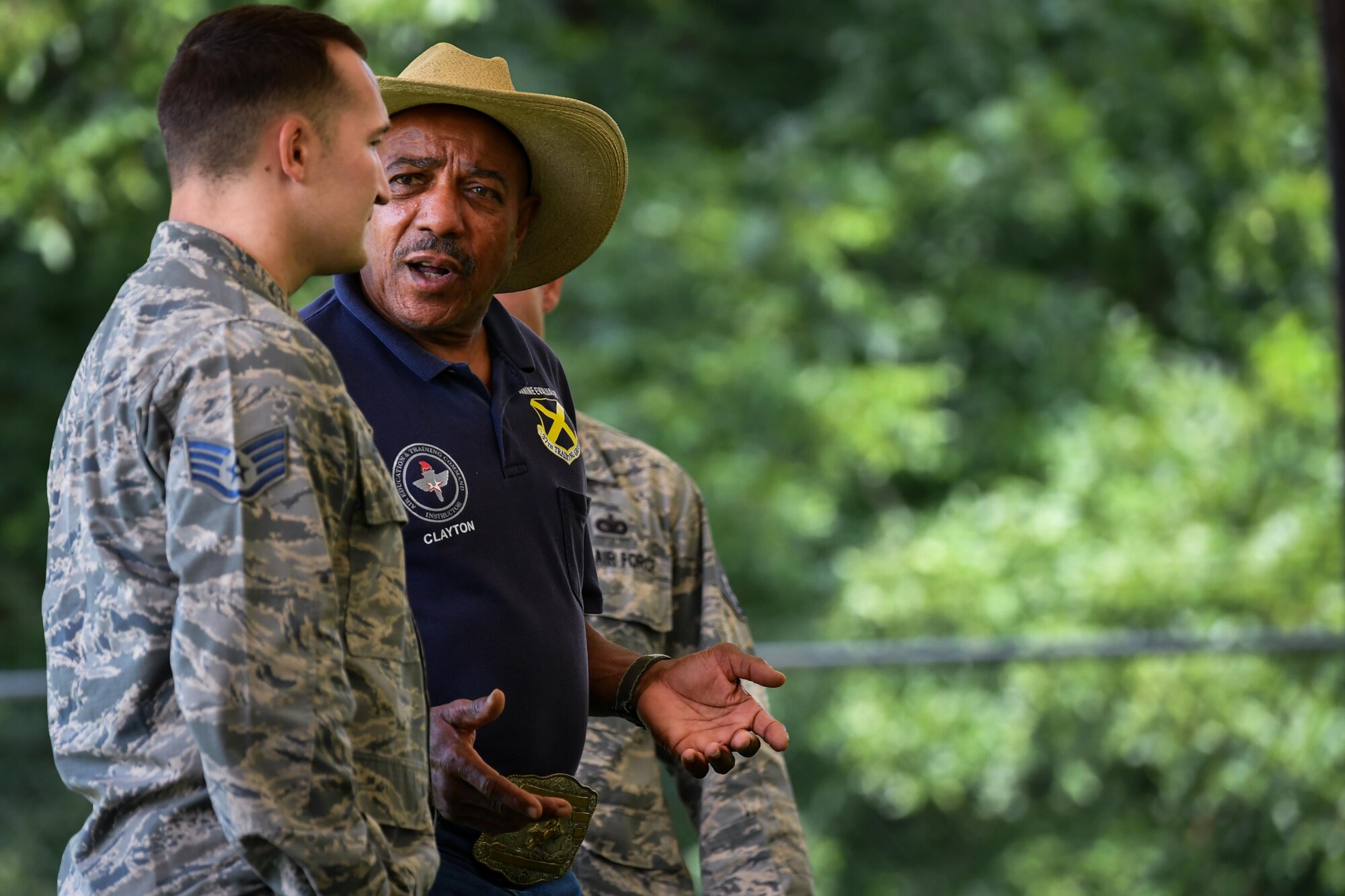 Mr. Oscar Clayton, 341st Training Squadron senior military working dog evaluator, speaks to Staff Sgt. Stephen Lammers, 2nd Security Forces Squadron MWD trainer during a patrol dog certification evaluation at Barksdale Air Force Base, La., Aug. 11, 2017. Clayton, a veteran dog handler and trainer, provided Lammers with guidance on training techniques.
