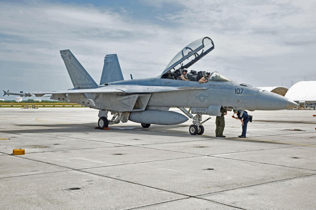 Lt. Drew Kocher and Lt. Cmdr. Brad Williams, both assigned to the "Fighting Swordsman" of Strike Fighter Squadron (VFA) 32, landed on Naval Air Station Key West's Boca Chica Field after completing Tactical Combat Training System's 100,000th pod-tracked sortie since the system began tracking using GPS technology in 2006.