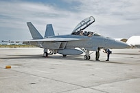 Lt. Drew Kocher and Lt. Cmdr. Brad Williams, both assigned to the "Fighting Swordsman" of Strike Fighter Squadron (VFA) 32, landed on Naval Air Station Key West's Boca Chica Field after completing Tactical Combat Training System's 100,000th pod-tracked sortie since the system began tracking using GPS technology in 2006.