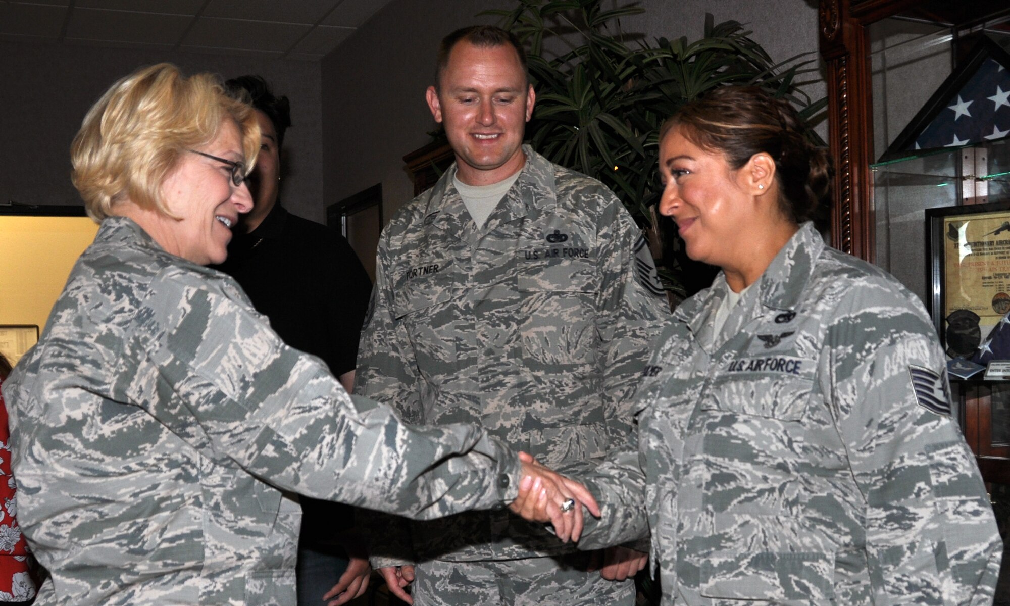 Air Force Maj. Gen. Kathryn Johnson, Director of Logistics, Air Force Reserve Command, coins Tech. Sgt. Silivia Bulmer, an air transportation journeyman assigned to the 82nd Aerial Port Squadron, Aug. 13, 2017, on Travis Air Force Base, California.