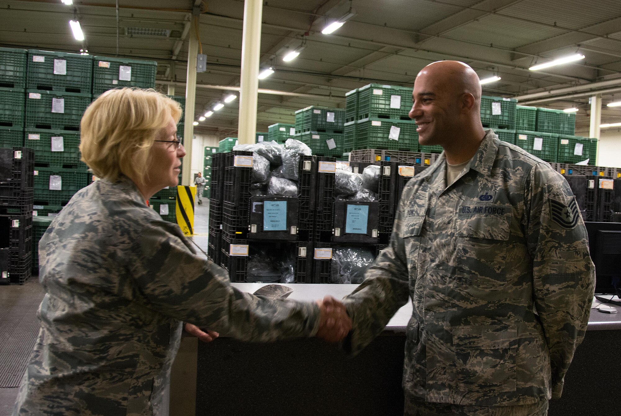 Maj. Gen. Kathryn Johnson, Air Force Reserve Command director of logistics, coins Tech. Sgt. Anthony Yon, 349th Logistics Readiness Squadron, at Travis Air Force Base, Calif., Aug. 14, 2017.