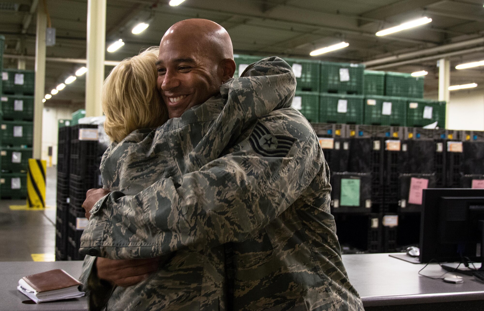 Maj. Gen. Kathryn Johnson, Air Force Reserve Command director of logistics, hugs Tech. Sgt. Anthony Yon, 349th Logistics Readiness Squadron, after giving him a coin at Travis Air Force Base, Calif., Aug. 14, 2017.