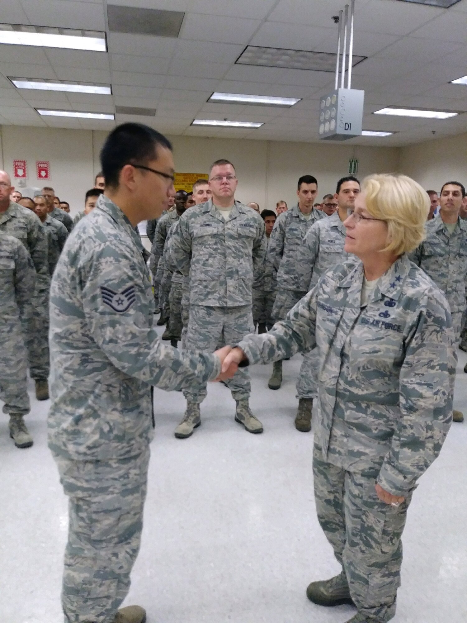 Staff Sgt. Kee Seok Kim, 349th Maintenance Squadron Unit Training Monitor, is coined by Maj. Gen. Kathryn Johnson, Director of Logistics, AFRC, at Travis Air Force Base, Calif., on Aug. 13, 2017.
