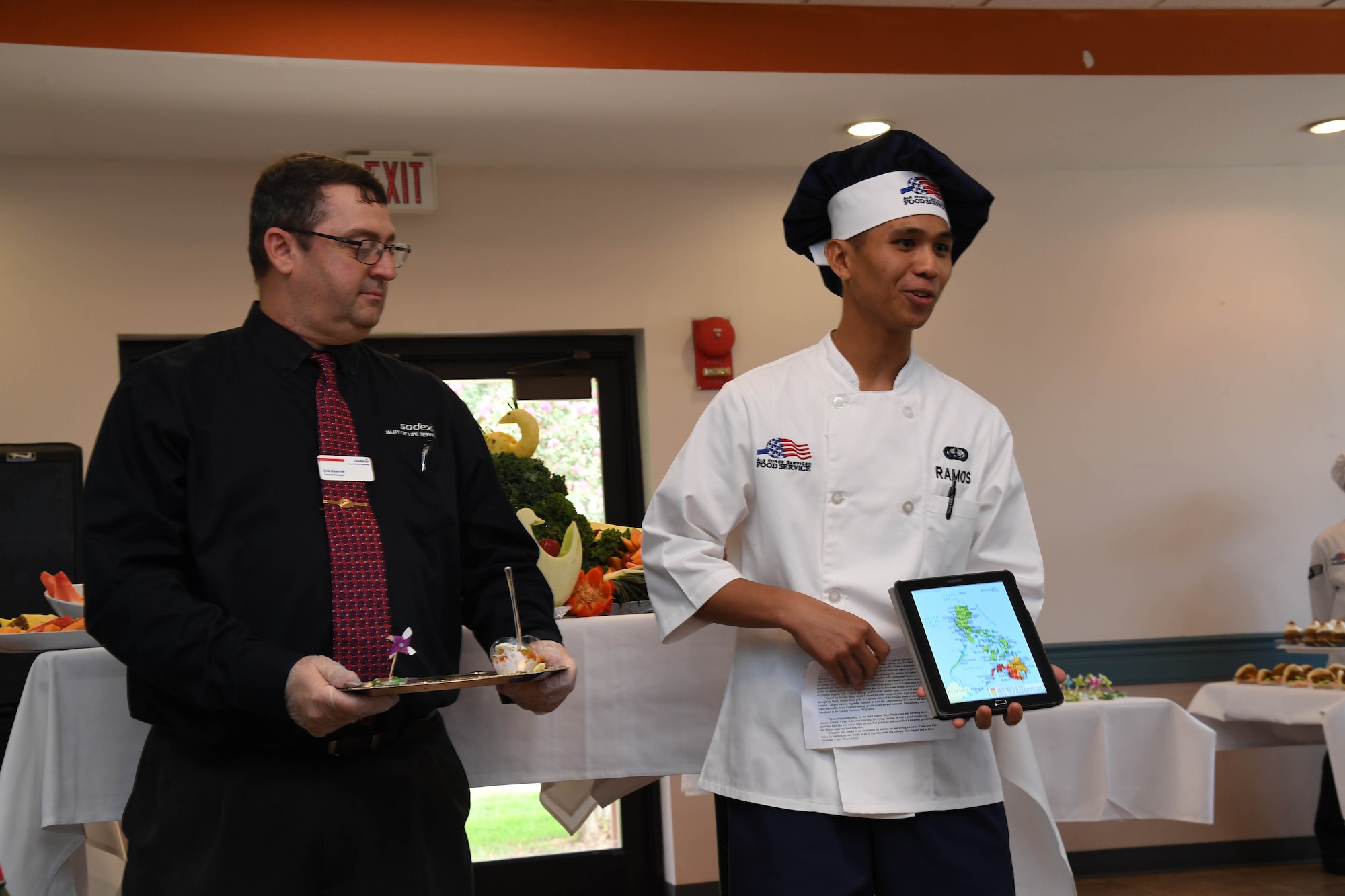 Airman Vick-Ramos Ramos, 2nd Force Support Squadron food services apprentice presents his dish during an advanced culinary skills course graduation at the Red River Dining Facility at Barksdale Air Force Base, La., Aug. 18, 2017.Ramos’ presentation included facts about the dishes’ origin and connection to the Philippines.