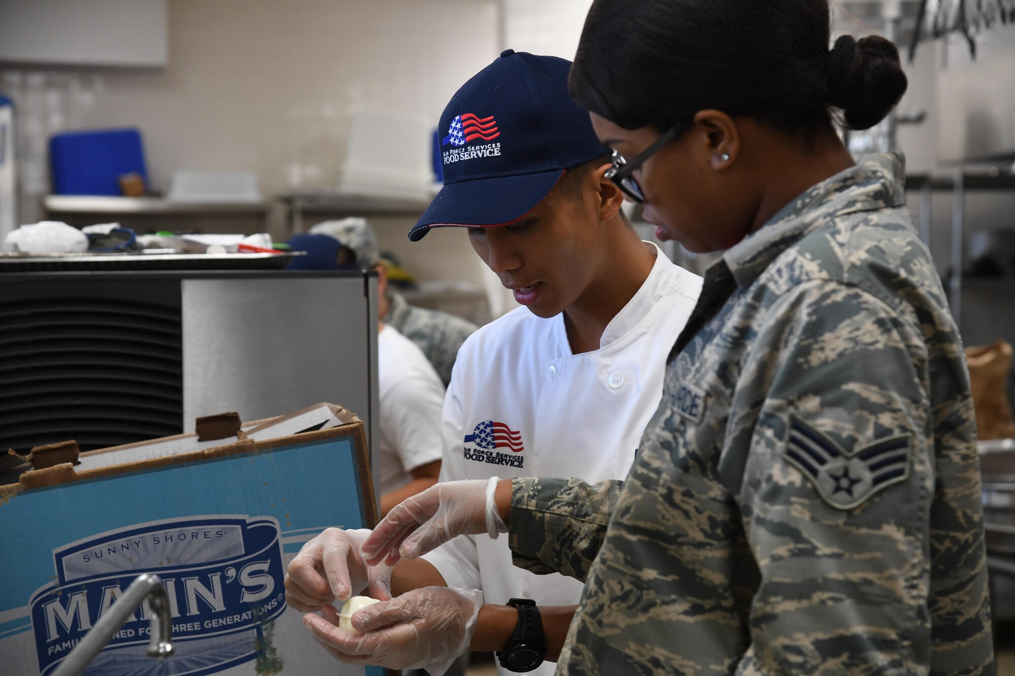 Airman 1st Class Lester Torres, 2nd Force Support Squadron food services apprentice prepares a garnish during an advanced culinary skills course graduation at the Red River Dining Facility at Barksdale Air Force Base, La., Aug. 18, 2017.Torres, demonstrated to other Airmen how to create a garnish using a hardboiled egg.