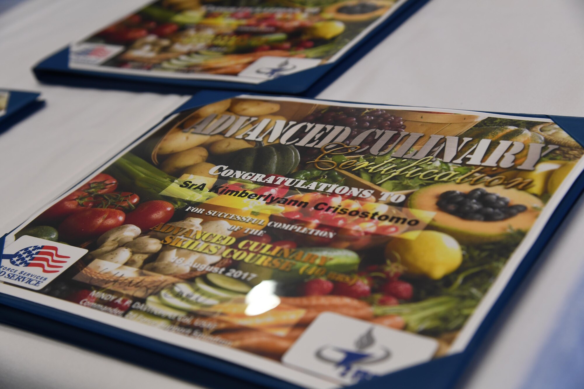 A graduation certificate is displayed during an advanced culinary skills course graduation at the Red River Dining Facility at Barksdale Air Force Base, La., Aug. 18, 2017. Five Airmen completed a two week long course in the services field to include advanced culinary skills and history of foods and culinary practices.