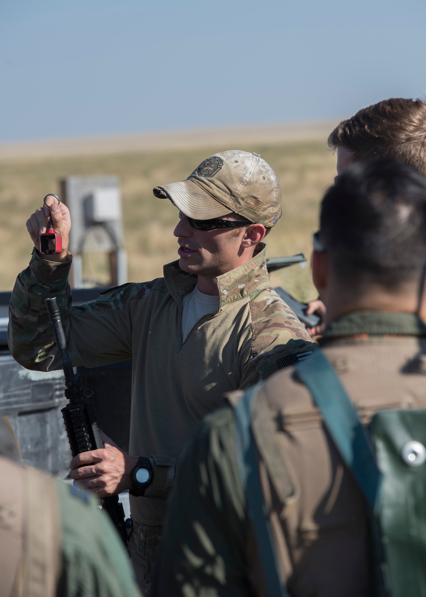 Staff Sgt. Cassidy Steffen, 366th Operations Support Squadron survival, evasion, resistance and escape specialist demonstrates how to secure a blank firing adapter during Combat Survival Training August 17, 2017, at Mountain Home Air Force Base, Idaho. CST is an in depth exercise that tests pilot’s abilities to evade enemy forces and put themselves in the best position to be rescued. (U.S. Air Force photo by Airman 1st Class Jeremy D. Wolff/Released)
