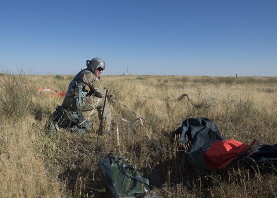 Tech Sgt. Isaac Denton, 366th Operations Support Squadron survival, evasion, resistance and escape specialist recovers his gear in a simulated landing during Combat Survival Training August 17, 2017, at Mountain Home Air Force Base, Idaho. SERE specialist’s primary mission is to support air crew by teaching them the best methods of survival in the event they need to eject. (U.S. Air Force photo by Airman 1st Class Jeremy D. Wolff/Released)