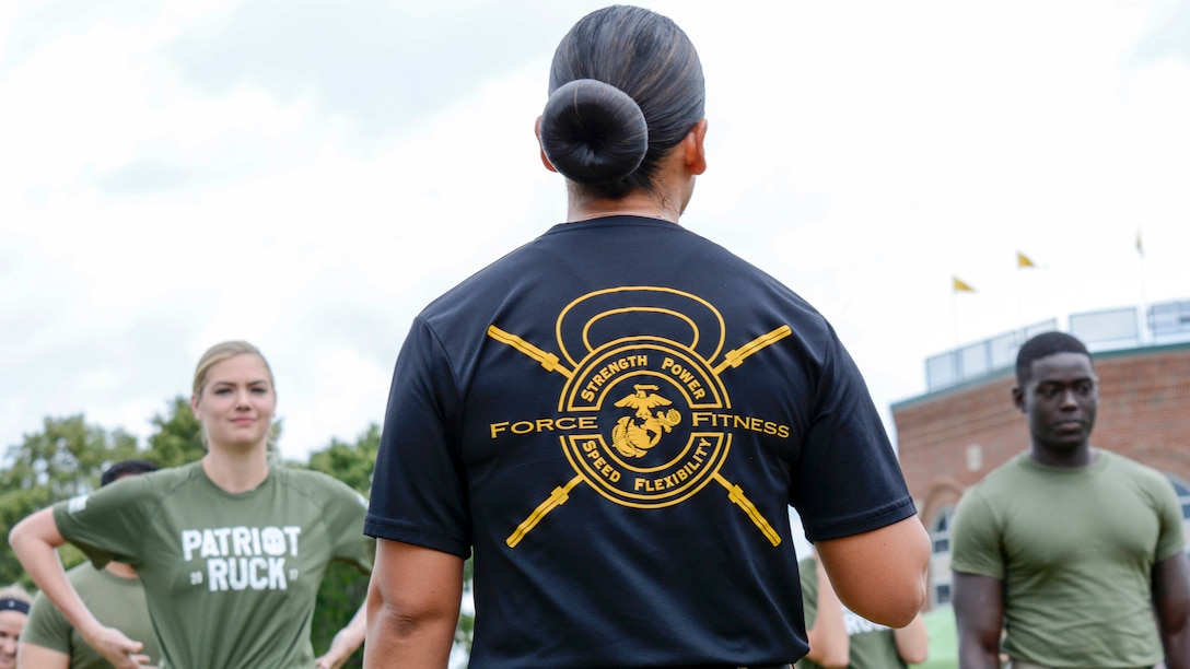 Kate Upton and others listen to instructions from GySgt. Sara Pacheco before executing a workout Wayne State University's athletic complex in Detroit on August 22. Upton and others completed a circuit course consisting of several rounds of burpees, sprints, jumping jacks and more in an effort to promote Marine Week Detroit that takes place Sept. 6-10. Marine Week Detroit is a four-day event that will showcase hands-on static displays, live demonstrations, time-honored Marine Corps traditions, musical performances and other events highlighting the history, military capabilities and community involvement of the Corps (U.S. Marine Corps Photo by GySgt. Joseph DiGirolamo)