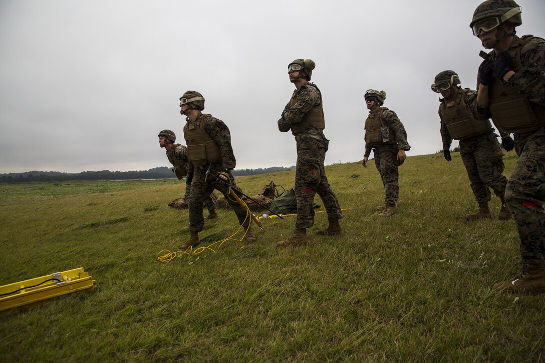 Landing support specialist Marines brace themselves from the rotor downwash of a CH-53E Super Stallion during external lifts training at Draughon Range near Misawa Air Base, Japan, August 21, 2017, in support of exercise Northern Viper 17. This combined-joint exercise is held to enhance regional cooperation between participating nations to collectively deter security threats. The Marines are assigned to Combat Logistics Battalion 4, Combat Logistics Regiment 3, 3rd Marine Logistic Group. (U.S. Marine Corps photo by Lance Cpl. Andy Martinez)
