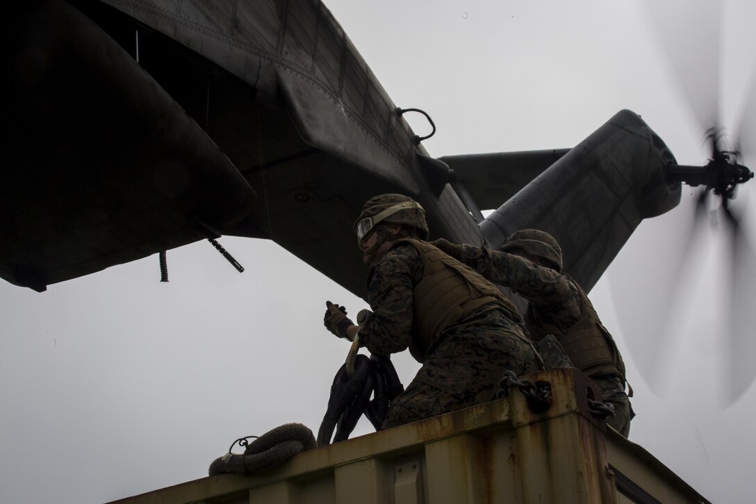 Pfc. Tyler J. Nye (left) and Cpl. Tyler D. Reed (right), both landing support specialist, prepare to attach a container to a CH-53E Super Stallion during external lifts training at Draughon Range near Misawa Air Base, Japan, August 21, 2017, in support of exercise Northern Viper 17. This combined-joint exercise is held to enhance regional cooperation between participating nations to collectively deter security threats. Nye, a Lincoln, Nebraska native, and Reed, a Waukesha, Wisconsin native, are assigned to Combat Logistics Battalion 4, Combat Logistics Regiment 3, 3rd Marine Logistic Group. (U.S. Marine Corps photo by Lance Cpl. Andy Martinez)