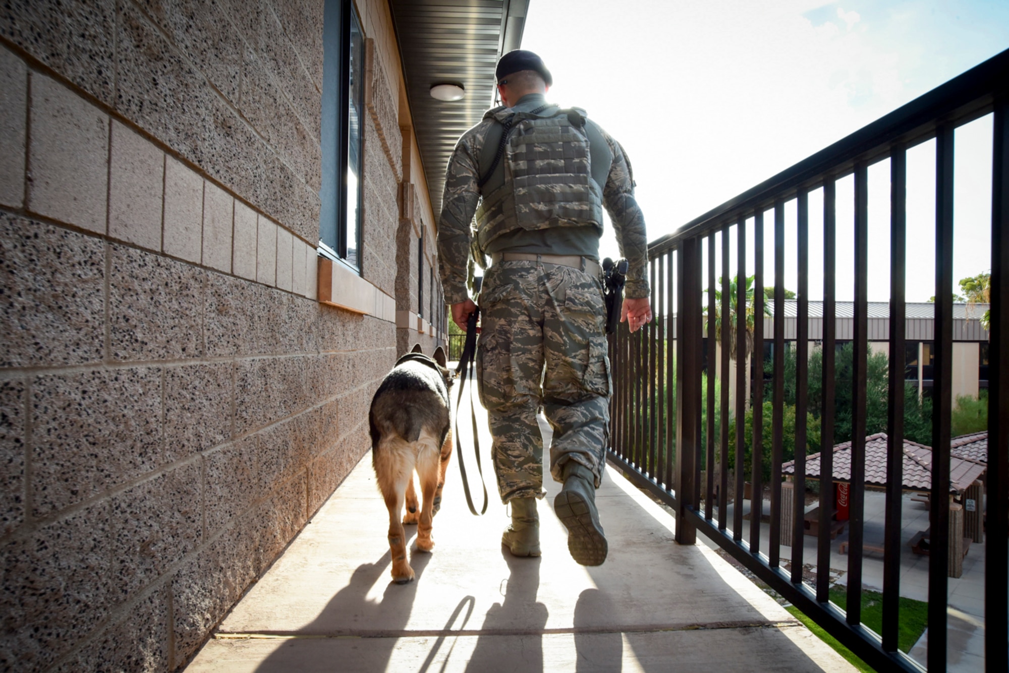 Senior Airman Ryne Wilson, 99th Security Forces Squadron military working dog handler, and MWD Habo patrol the dorms at Nellis Air Force Base, Nevada, August 7, 2017. Wilson and Habo perform dorm patrols to ensure the safety and security of the Airmen living there. (U.S. Air Force photo by Airman 1st Class Andrew D. Sarver/Released)