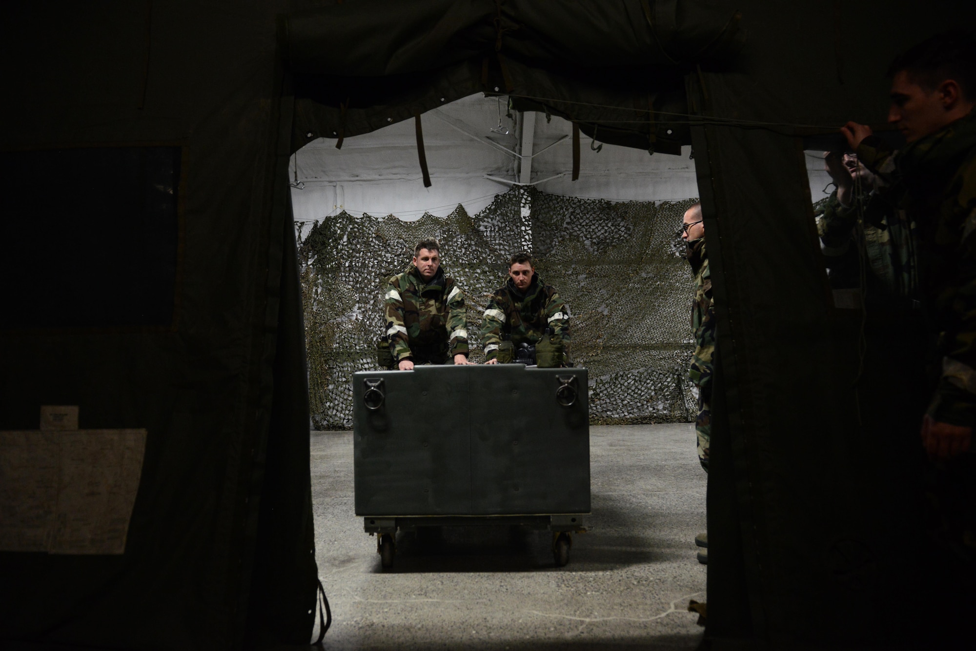 Airmen clean up after a Chemical, Biological, Radiological, and Nuclear defense survival skills training class hosted by the 773d Civil Engineer Squadron emergency management flight at Joint Base Elmendorf-Richardson, Alaska, Aug. 22. The two-hour CBRN class reminds Airmen of the various equipment and proper procedures used pre- and post-attack, and puts the Airmen’s knowledge to the test with an application of this information in full Mission Oriented Protected Posture gear.