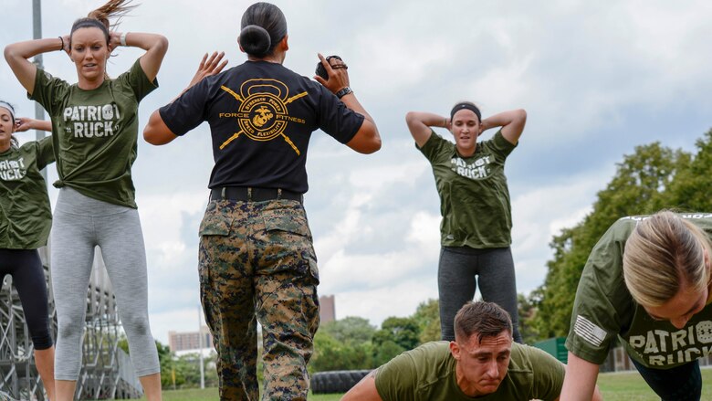 Gunnery Sgt. Sara Pacheco, force fitness instructor, shouts instructions during a workout at Wayne State University's athletic complex in Detroit on Aug. 22, 2017. Pacheco led Kate Upton, the Detroit Tigers Wives, and Marines through a circuit course consisting of several rounds of burpees, sprints, jumping jacks and more in an effort to promote Marine Week Detroit that takes place Sept. 6-10. Marine Week Detroit is a four-day event that will showcase hands-on static displays, live demonstrations, time-honored Marine Corps traditions, musical performances and other events highlighting the history, military capabilities and community involvement of the Corps