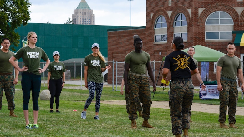 Kate Upton and others listen to instructions from GySgt. Sara Pacheco before they executed a workout at Wayne State University's athletic complex in Detroit on Aug. 22, 2017. Upton and others completed a circuit course consisting of several rounds of burpees, sprints, jumping jacks and more in an effort to promote Marine Week Detroit that takes place Sept. 6-10. Marine Week Detroit is a four-day event that will showcase hands-on static displays, live demonstrations, time-honored Marine Corps traditions, musical performances and other events highlighting the history, military capabilities and community involvement of the Corps.