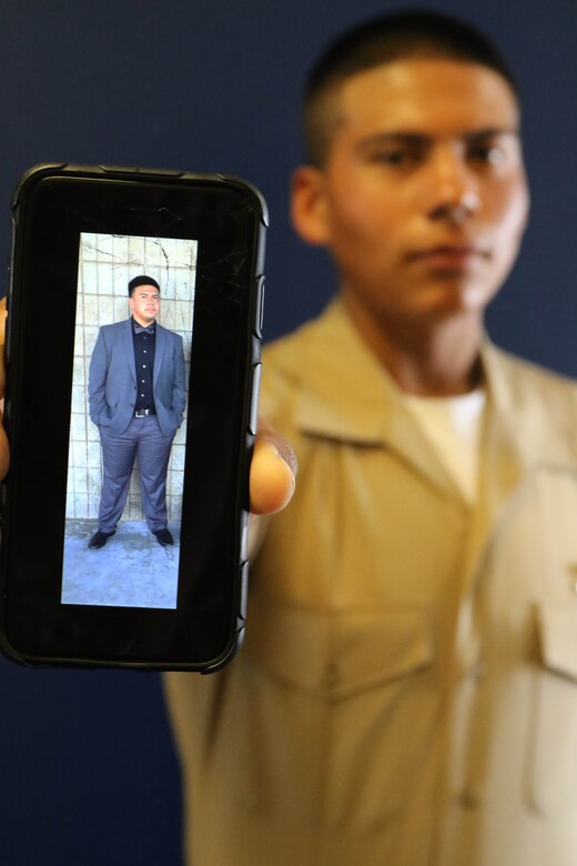 Private Brian J. Rodriguez-Martinez of Recruiting Sub Station Bakersfield East, Recruiting Station Los Angeles, and graduate of East Bakersfield High School shows a photo of himself where he weighed his heaviest at 242 pounds in 2016. By working out consistently and eating healthy, he lost more than 70 pounds and earned the title of United States Marine. (U.S. Marine Corps photo by Staff Sgt. Alicia R. Leaders/Released)