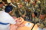 Alonzo Gonzales, a combat medic program emergency medical technician course instructor at the Medical Education and Training Campus at Joint Base San Antonio-Fort Sam Houston, lectures students in Alpha Class 70-17 about different obstetrics complications  utilizing a specialized OB training manikin. The OB manikins resemble life-size pelvic cavities inside which the “fetus” can be positioned to replicate any number of complicated situations.