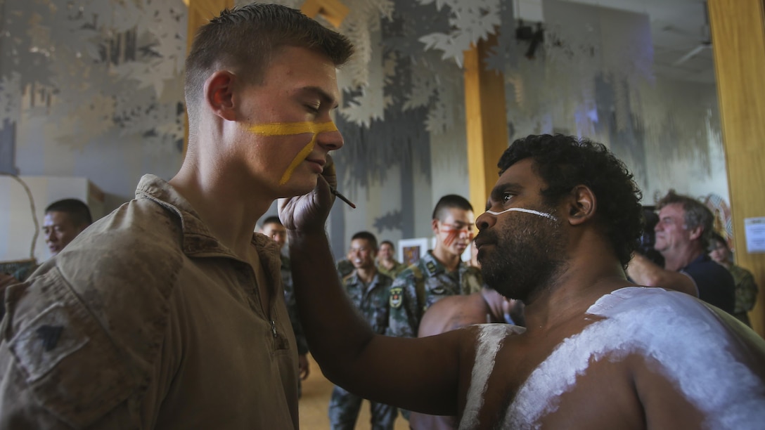 CAIRNS, Australia – U.S. Marine Cpl. Micheal Smith, left, rifleman, Company K, 3rd Battalion, 4th Marine Regiment, Marine Rotational Force Darwin, has an Aboriginal design painted on his face during Indigenous Australian culture classes conducted as part of Exercise Kowari 2017 Aug. 23, 2017. The soldiers and Marines also took part in boomerang throwing and hut building to familiarize them with Indigenous Australian culture. Kowari is an annual training activity held in Australia to reinforce trilateral military relationships, trust and co-operation between Australia, China and the United States. (U.S. Marine Corps photo by Sgt. Emmanuel Ramos)