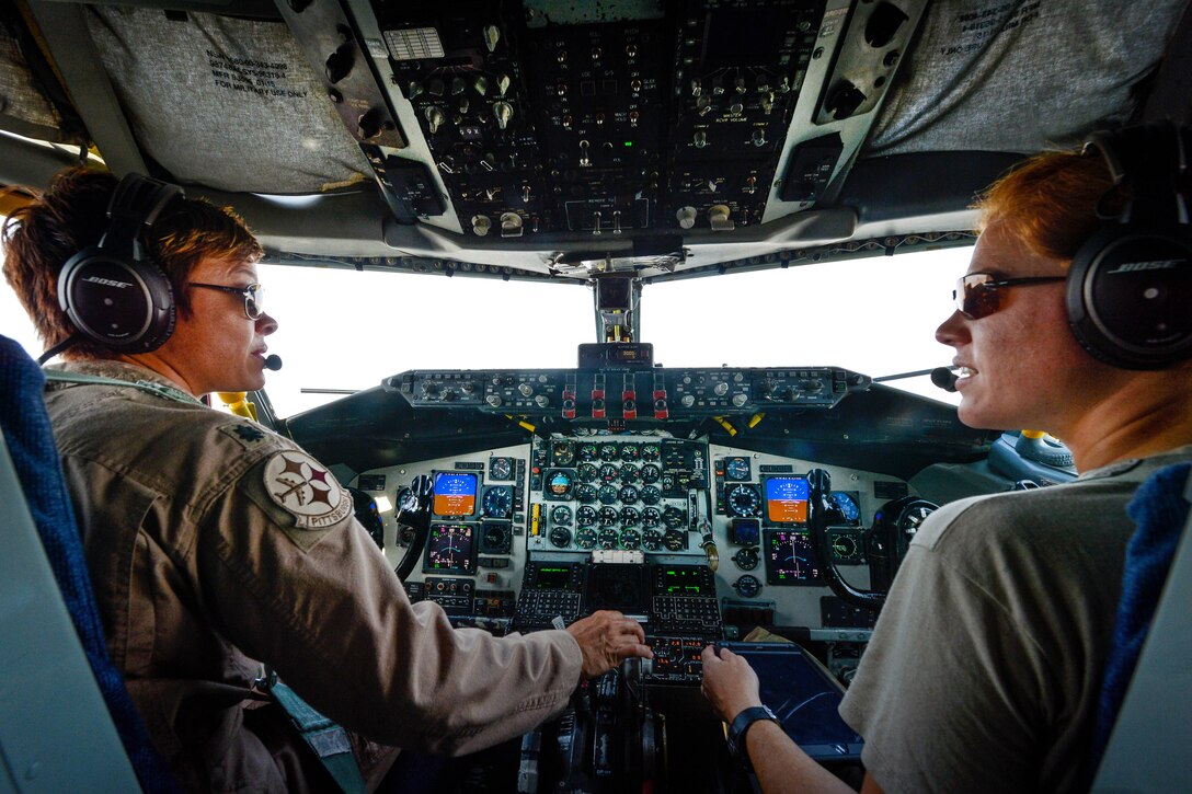 Air Force pilots communicate with the crew aboard a KC-135 Stratotanker.