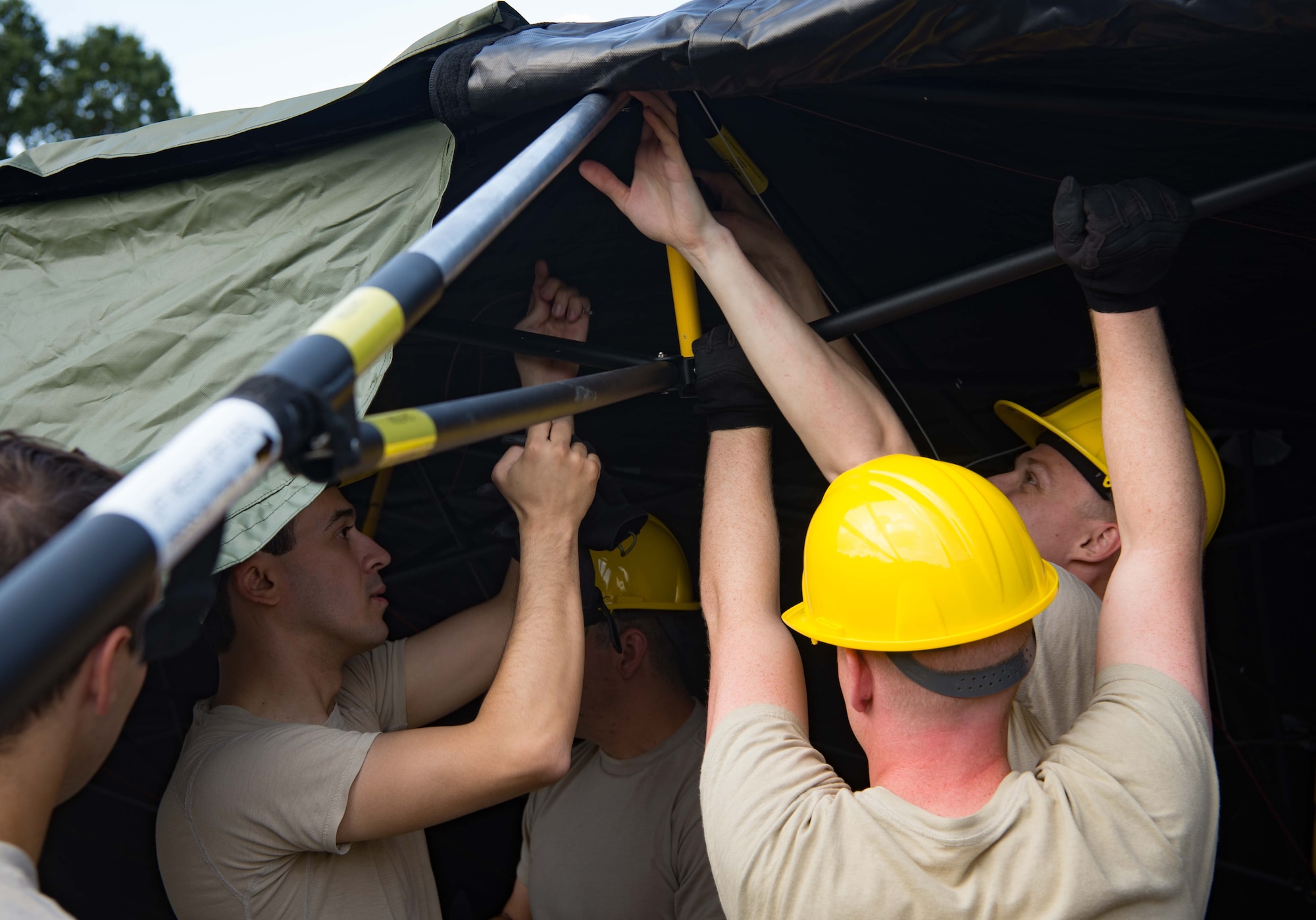 U.S. Airmen assigned to the 1st Combat Communications Squadron repair and assemble a communications tent during Exercise Lending Hand on Ramstein Air Base, Germany, Aug. 21, 2017.