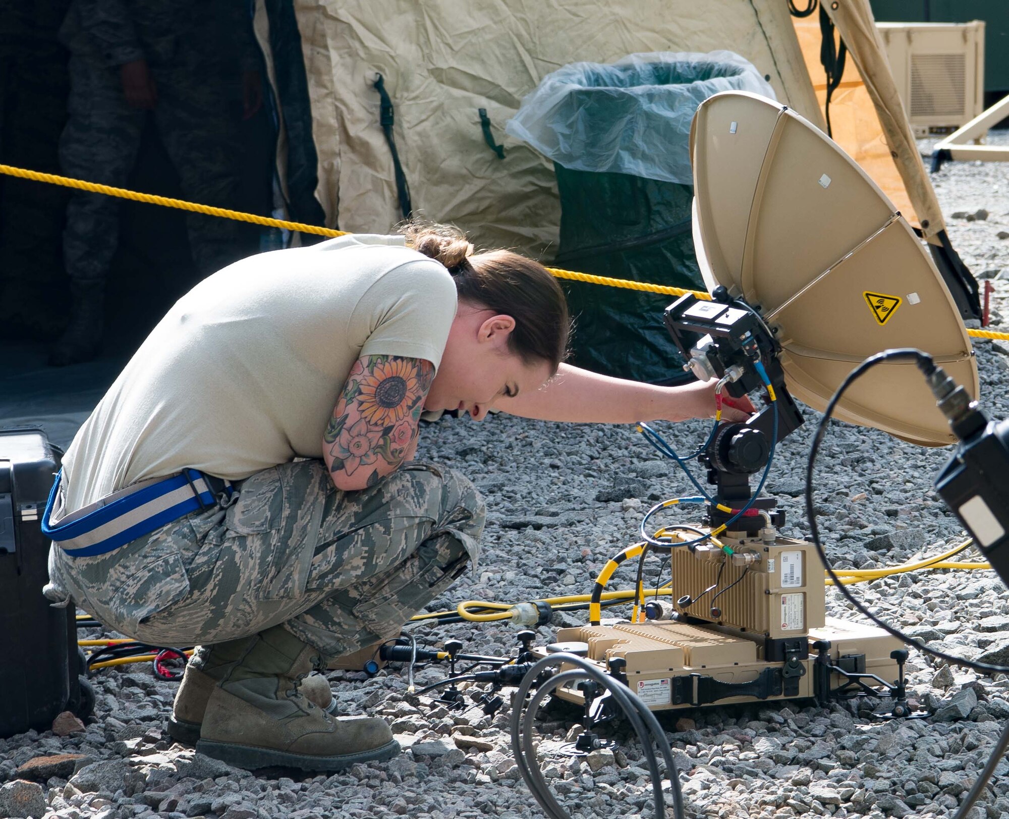 U.S. Air Force Senior Airman Elizabeth Arthur, 1st Combat Communications Squadron radio frequency transmission systems technician, adjusts a communications satellite during Exercise Lending Hand on Ramstein Air Base, Germany, Aug. 21, 2017.