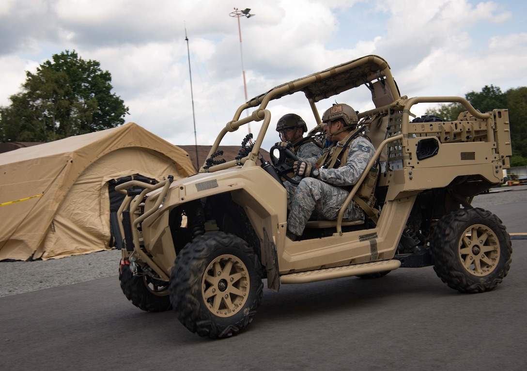 U.S. Airmen assigned to the 435th Security Forces Squadron drive an all-terrain vehicle through the exercise area for Exercise Lending Hand on Ramstein Air Base, Germany, Aug. 21, 2017.