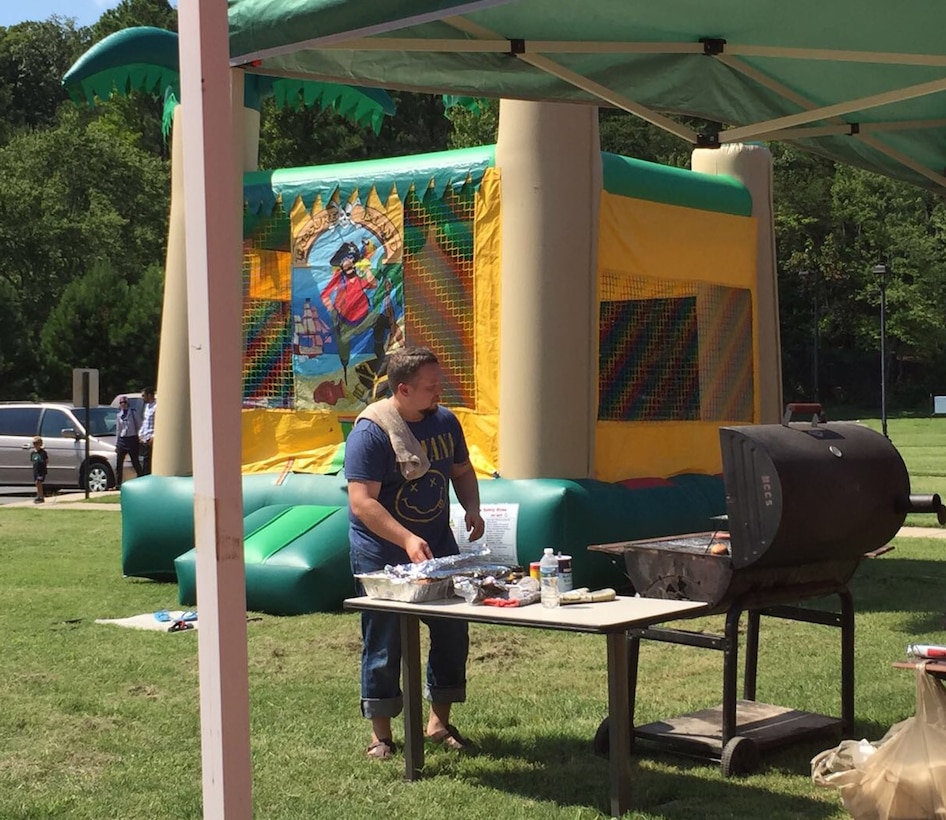 Jason Gregoire, chef extraordinaire for the Muslim fellowship gathering, prepares hamburgers and hotdogs for the cookout-style event.