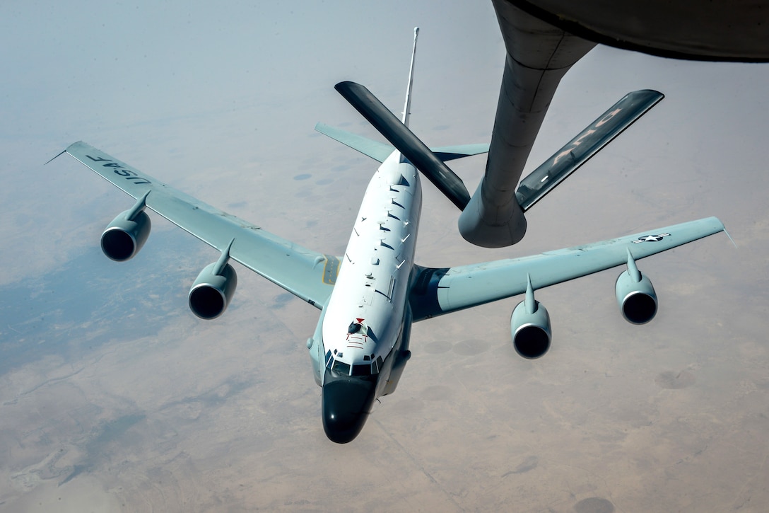 An RC-135V/W Rivet Joint aircraft departs after receiving fuel.