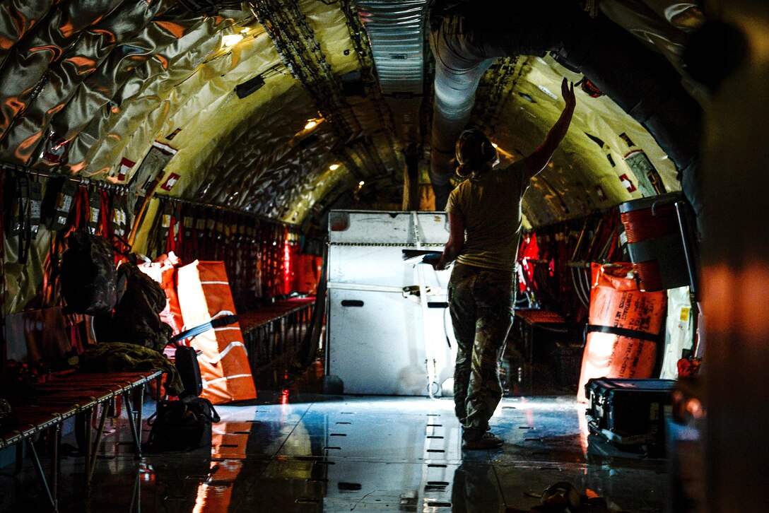 An Air Force airman checks the temperature within a KC-135 Stratotanker.