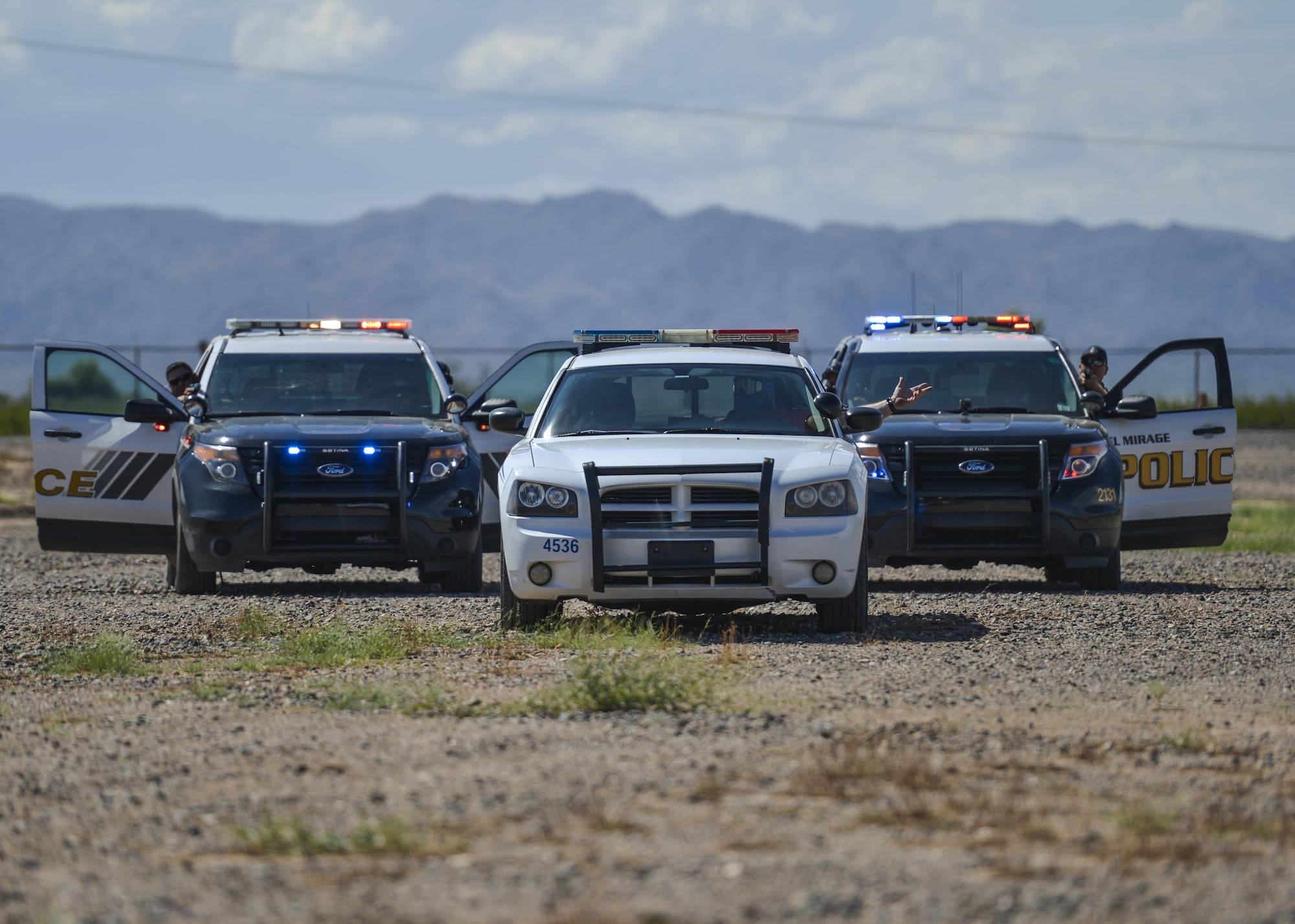 Police officers from around Maricopa County stage an arrest during an exercise as part of an Emergency Vehicle Operations Course held at Luke Air Force Base, Ariz., Aug. 21, 2017. The EVOC training provided hands-on, realistic training to the 56th Security Forces Squadron as well as local police departments. (U.S. Air Force photo/Airman 1st Class Caleb Worpel)