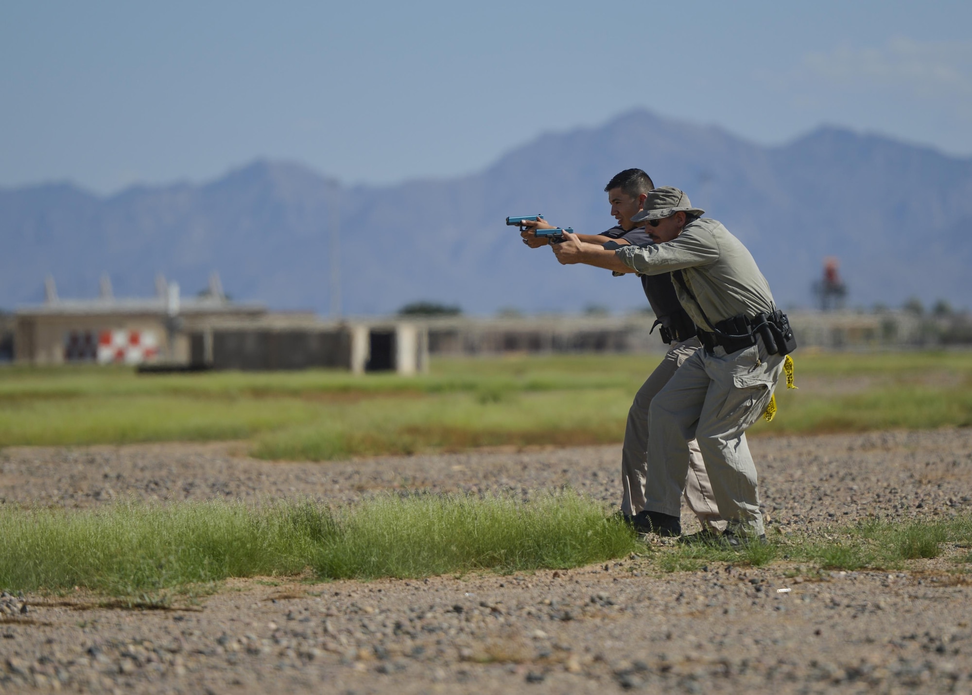 Police officers from around Maricopa County approach an apprehended vehicle during an exercise as part of an Emergency Vehicle Operations Course held at Luke Air Force Base, Ariz., Aug. 21, 2017. The EVOC training is scheduled to take place in the future as part of an ongoing partnership between local police departments and Luke Air Force Base. (U.S. Air Force photo/Airman 1st Class Caleb Worpel)