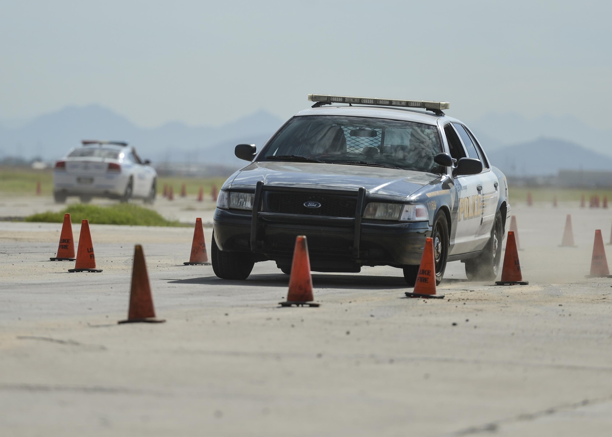 A city of El Mirage police cruiser is driven through a staged as part of an Emergency Vehicle Operations Course held at Luke Air Force Base, Ariz., Aug. 23, 2017. The EVOC training is scheduled to take place in the future as part of an ongoing partnership between local police departments and Luke Air Force Base. (U.S. Air Force photo/Airman 1st Class Caleb Worpel)