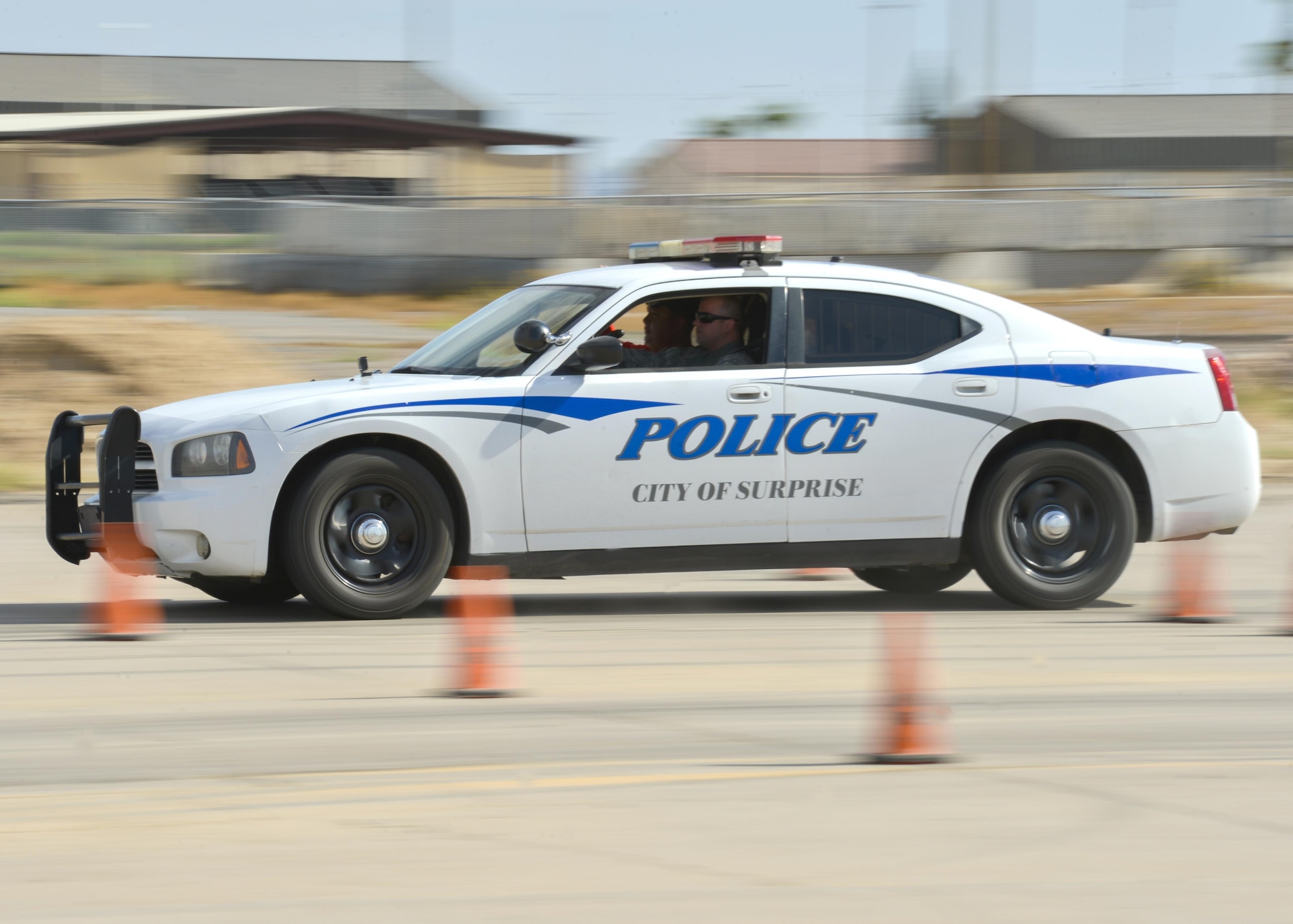 A city of Surprise police cruiser is driven through a staged course as part of an Emergency Vehicle Operations Course held at Luke Air Force Base, Ariz., Aug. 23, 2017. The EVOC training provided hands-on, realistic training to the 56th Security Forces Squadron as well as local police departments. (U.S. Air Force photo/Airman 1st Class Caleb Worpel)
