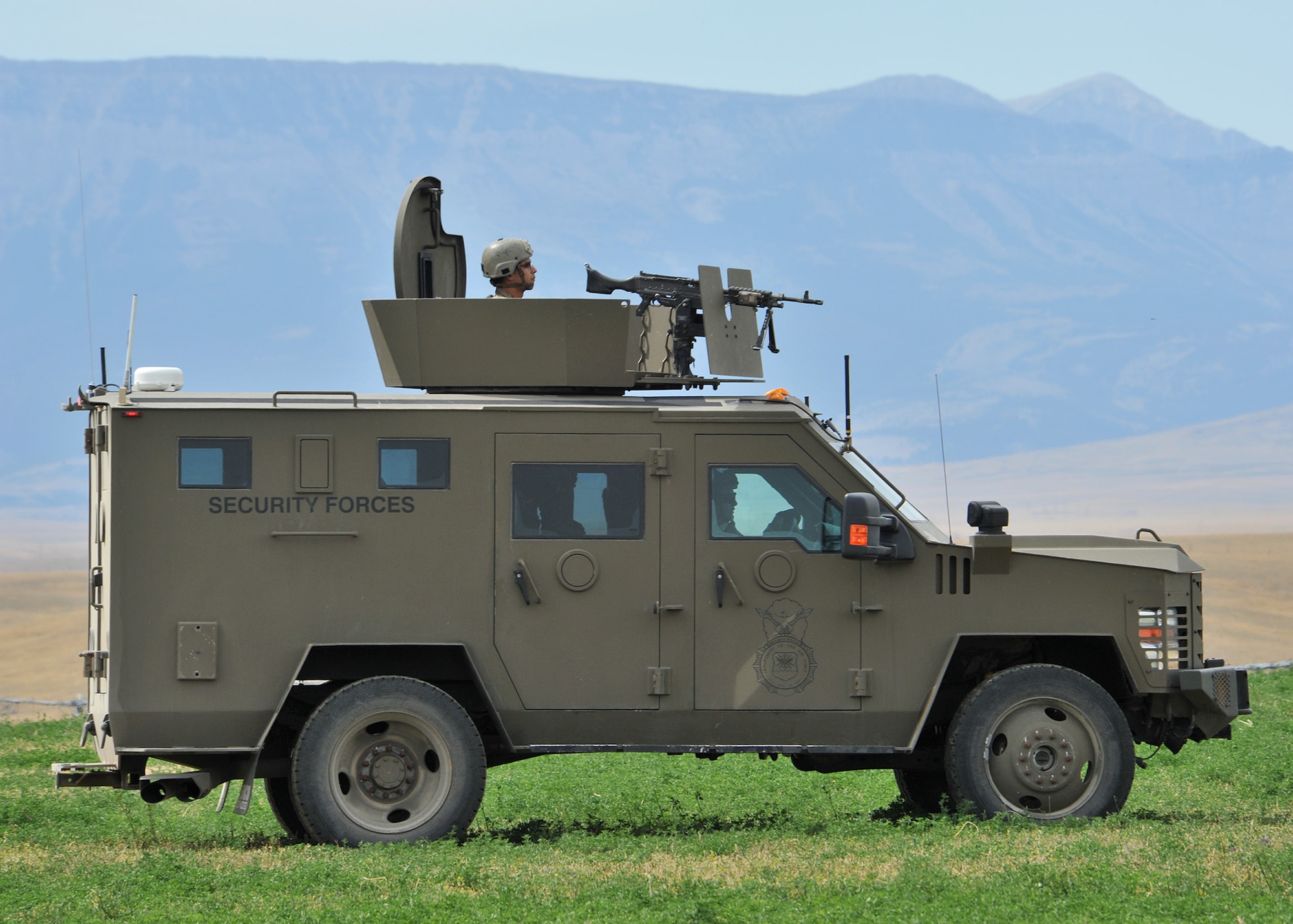 A Bearcat armored vehicle from the 741st Missile Security Forces Squadron Convoy Response Force guards a payload transporter at the start of a Local Integrated Response Plan exercise Aug. 16, 2017, near Choteau, Mont.