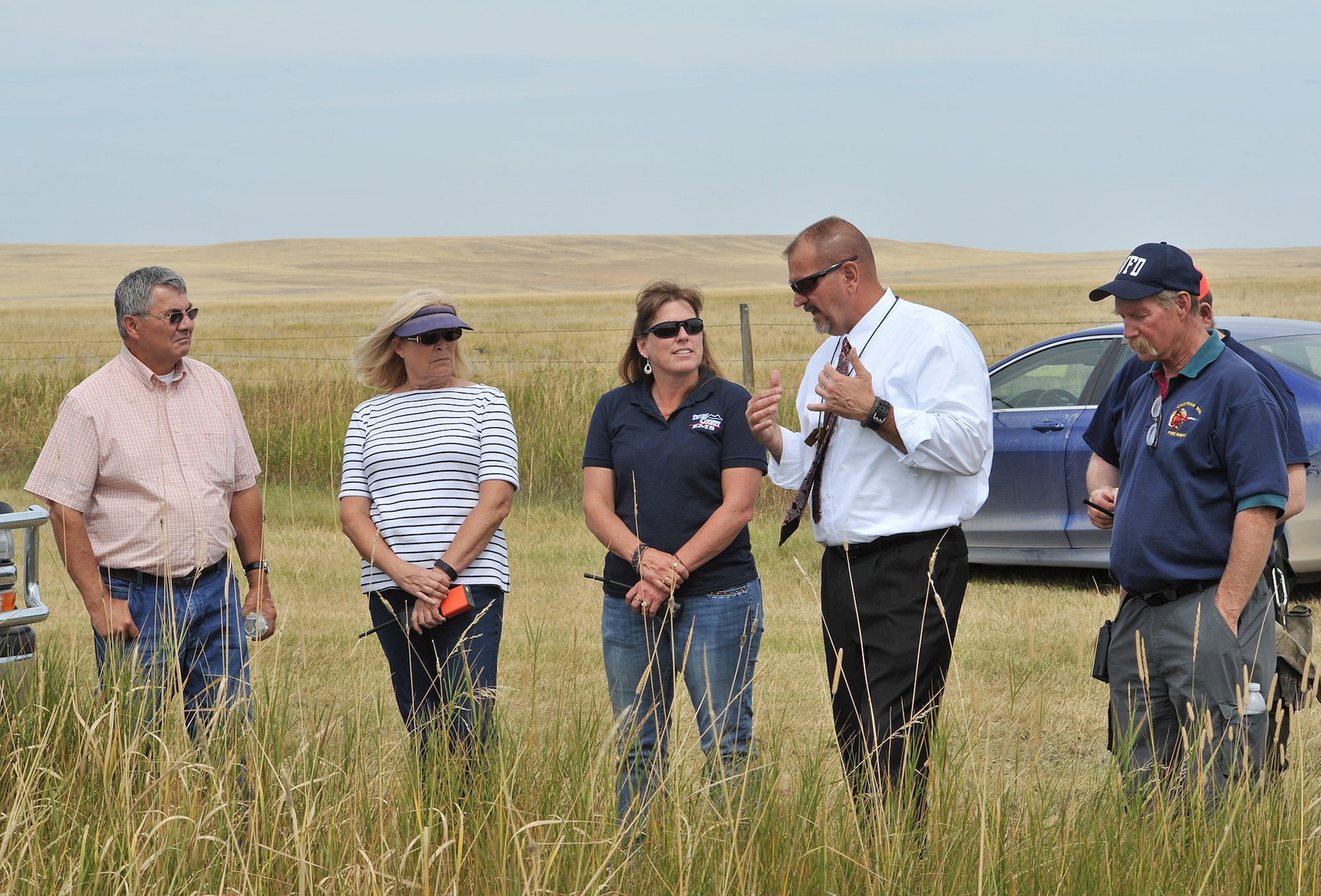 Stanley Moody, 341st Security Forces Group plans and projects manager, center, speaks with representatives from Teton County Emergency Medical Services and the Choteau Volunteer Fire Department during a Local Integrated Response Plan exercise Aug. 16 near Choteau, Mont.