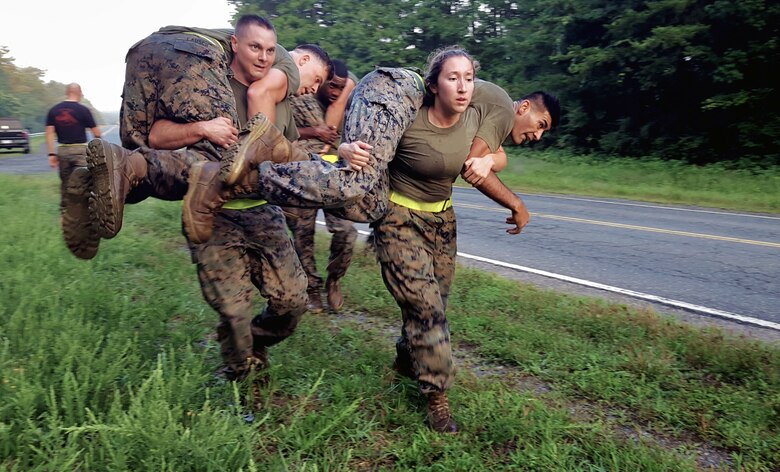 As part of the physical training session Marines fireman carried fellow Marines alongside MCB-1 leading from the Marine Corps Embassy Security Group building.