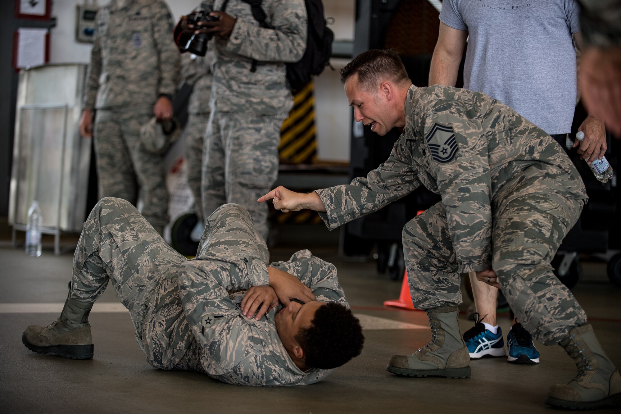 U.S. Air Force Senior Master Sgt. Jerry Peterson, 86th Maintenance Group quality assurance superintendent, motivates Airman Javon Richard, 86th Maintenance Squadron aerospace ground equipment technician, during the Maintainer Olympics in the dual hangar bay on Ramstein Air Base, Germany, Aug. 24, 2017.