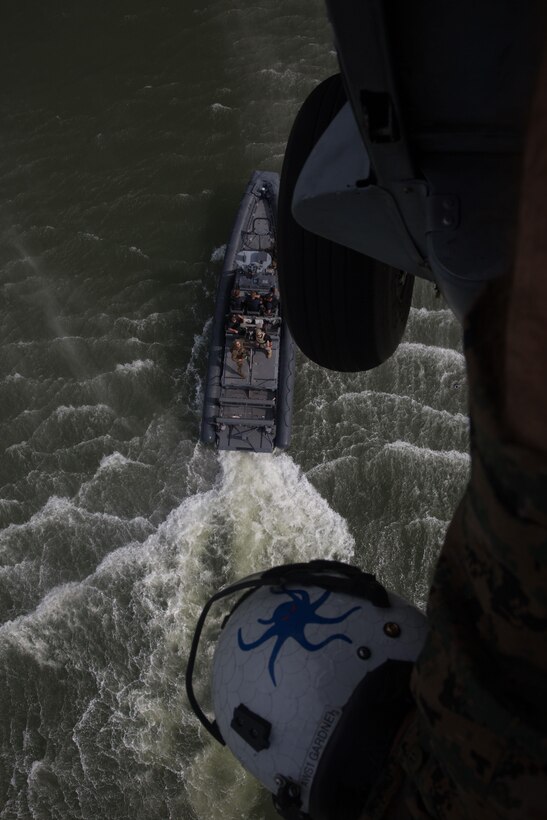U.S. Marines with the Maritime Raid Force (MRF), 26th Marine Expeditionary Unit (MEU), evacuate a simulated casualty using a hoist from a U.S. Navy MH-60S Seahawk aircraft during visit, board, search and seizure (VBSS) training at Fort Eustis, Va., Aug. 2, 2017.
