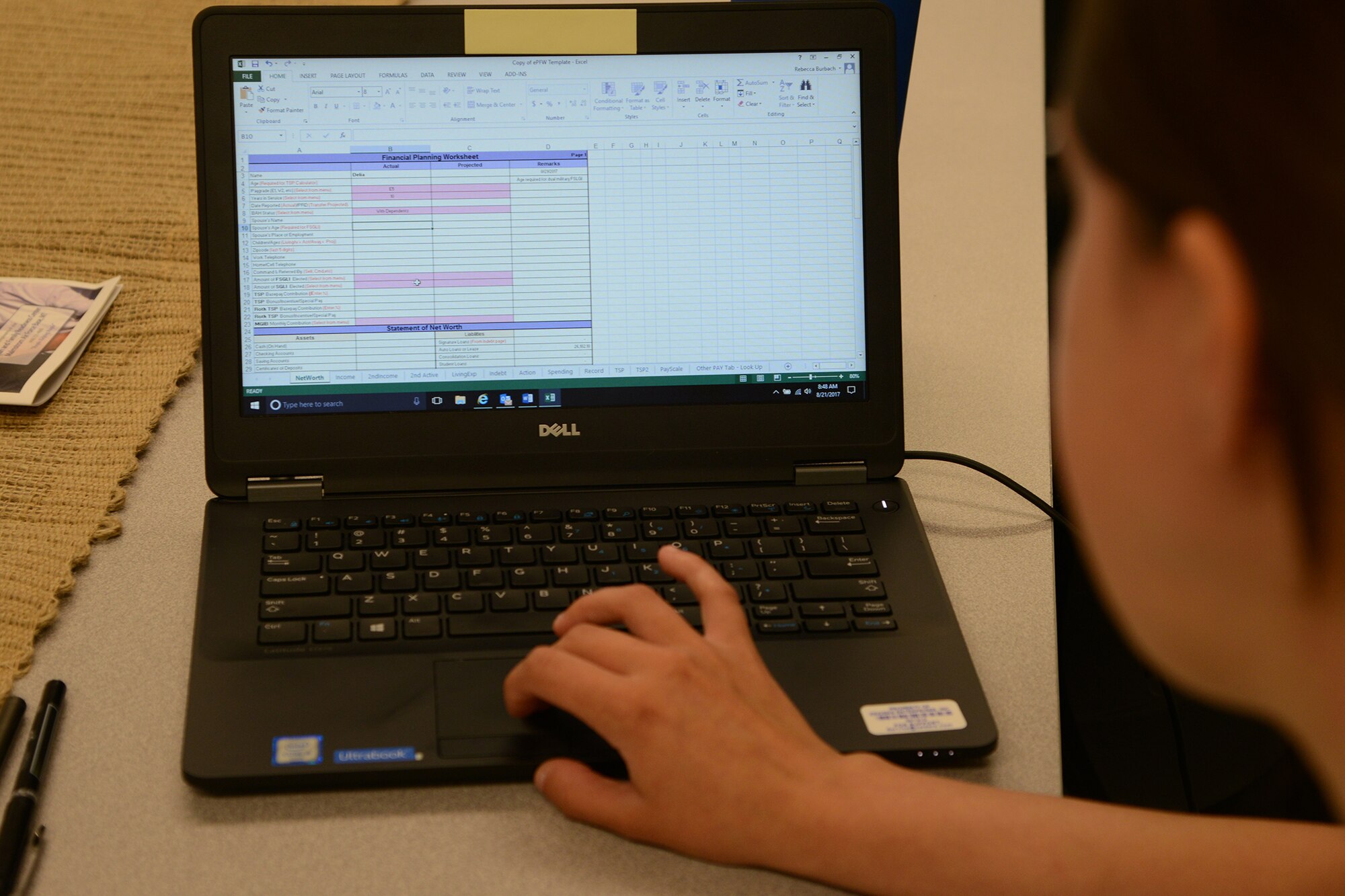 Rebecca Burbach, Malmstrom personal financial counselor, reviews a personalized financial worksheet for a customer Aug. 21, 2017, at Malmstrom Air Force Base, Mont.