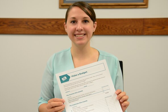 Rebecca Burbach, Malmstrom personal financial counselor, displays one of many budget resource tools available for customers Aug. 21, 2017, at Malmstrom Air Force Base, Mont.