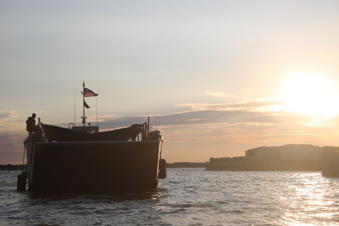 A U.S Army landing craft, mechanized (LCM) approaches the shore to offload U.S. Marines with the Maritime Raid Force (MRF), 26th Marine Expeditionary Unit (MEU), during visit, board, search and seizure (VBSS) training at Fort Eustis, Va., Aug. 2, 2017.