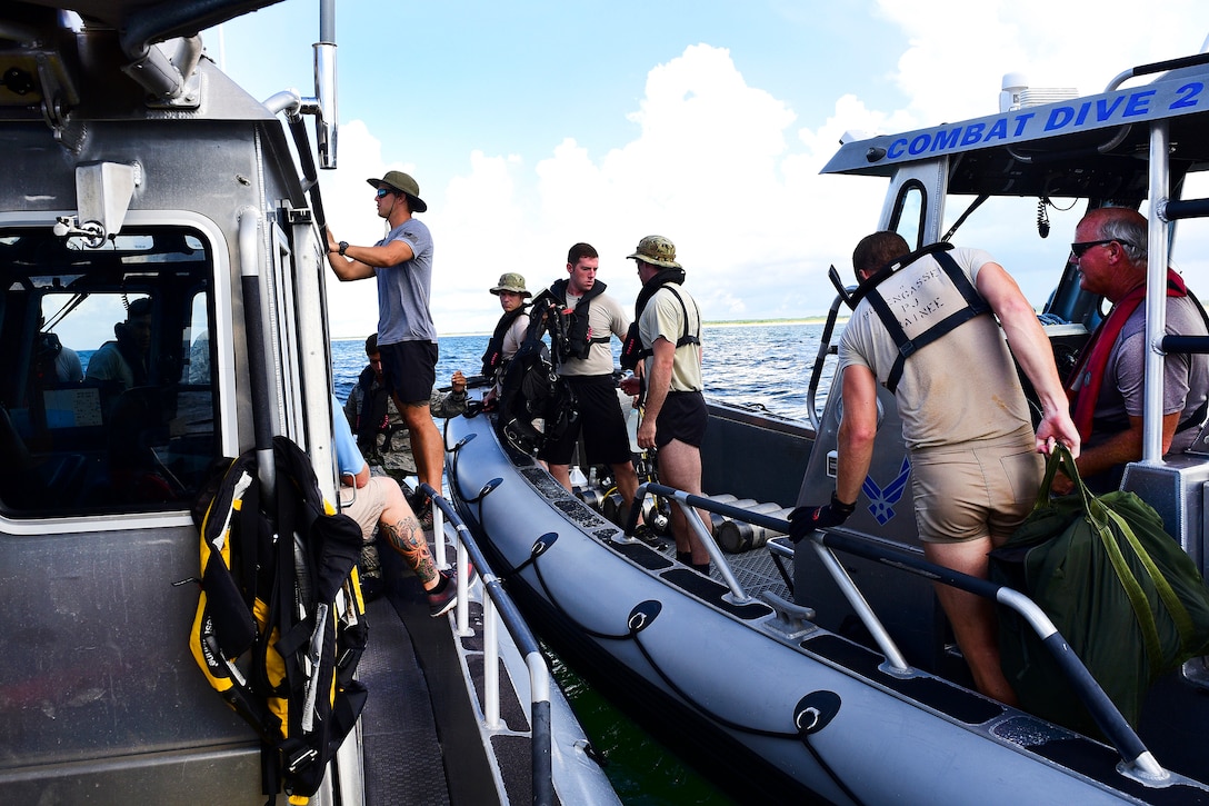 Naval Diving and Salvage Training Center instructors and Air Force airmen prepare for a recovery exercise.