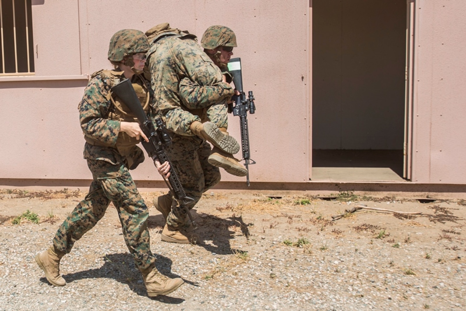 A U.S. Marine with Combat Logistics Battalion 13 provides security while a simulated casualty is transported to safety during a field medical training exercise on Marine Corps Base Camp Pendleton, Calif., Jul. 18, 2017. The Marines are placed in scenarios meant to test them not only tactically through patrolling but also establishing and securing an expedient casualty collection point, assessment, treatment and triage of all casualties, and movement of patient under fire to a landing zone.