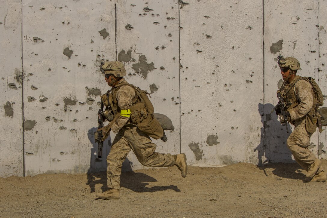 Marines with 2nd Battalion, 7th Marine Regiment, 1st Marine Division, sprint to their next objective while assaulting an urban environment during a Marine Corps Combat Readiness Evaluation (MCCRE) at Marine Air Ground Combat Center Twentynine Palms, Calif., July 15, 2017. The 2/7 MCCRE is in preparation for the upcoming deployment with the Special Purpose Marine Air Ground Task Force. (U.S. Marine Corps photo by Cpl. Justin Huffty)