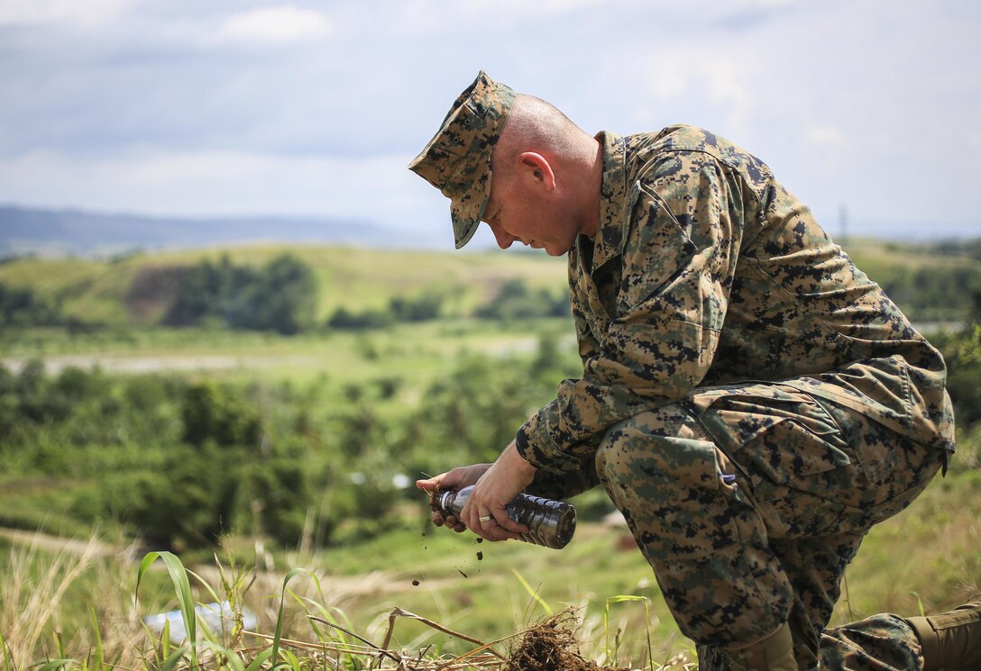 U.S. Marine Corps Sgt. Maj. William T. Sowers, sergeant major of 1st Marine Division, collects soil during a tour of Bloody Ridge in Guadalcanal, Solomon Islands, Aug. 9, 2017. The tour was used to teach the Marines about Bloody Ridge and the Battle of Guadalcanal, which took place from Aug. 7, 1942 to Feb. 9, 1943. (U.S. Marine Corps photo by Sgt. Wesley Timm)